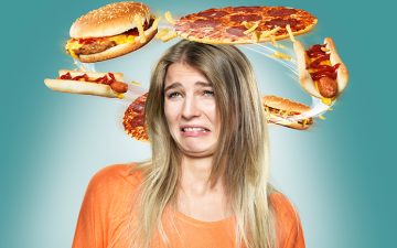 Image of a distressed woman with fastfood circling her head