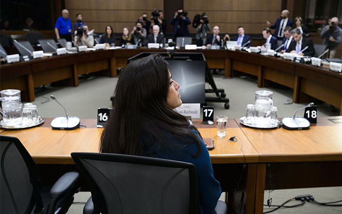 Jody Wilson-Raybould sitting at a set of tables in a circle